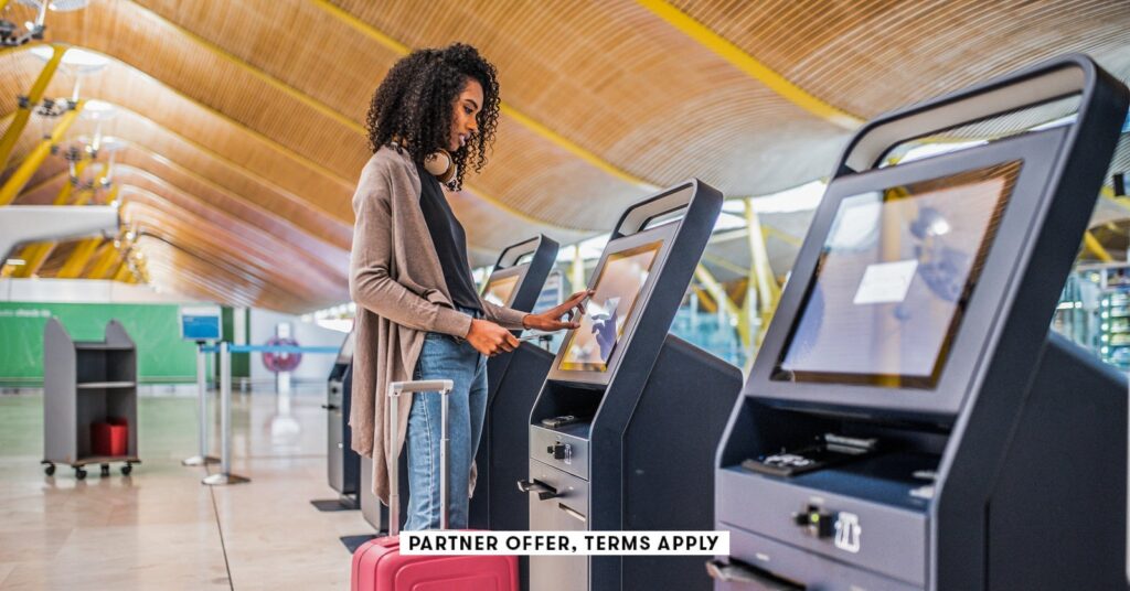 Amex airline credit: replace after Spirit's shutdown social image partner offer terms apply woman using the check in machine at the airport david prado 7.jpeg