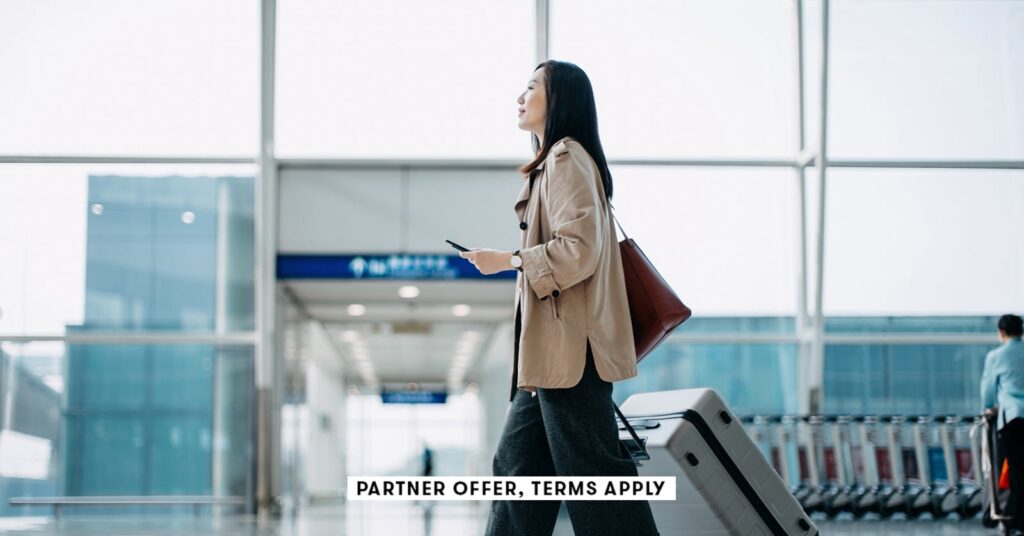 young womanc walking throught airport with suitcase d3sign social.jpg