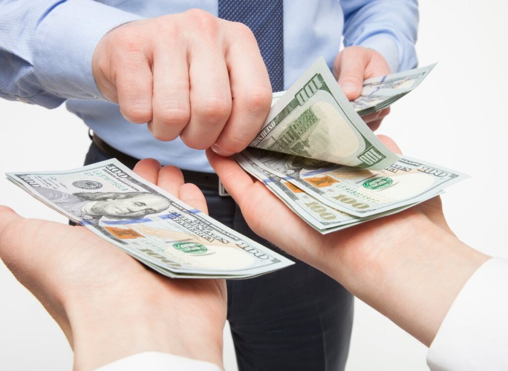 2 Dividend Shares to Purchase and Grasp Ceaselessly urlhttps3a2f2fg.foolcdn.com2feditorial2fimages2f8702702fperson placing money in both hands.jpeg