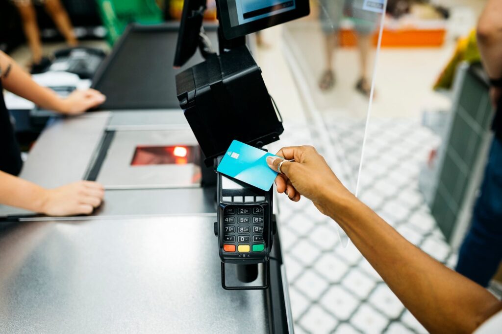 close up of person paying with credit card at store jordi salas.jpg