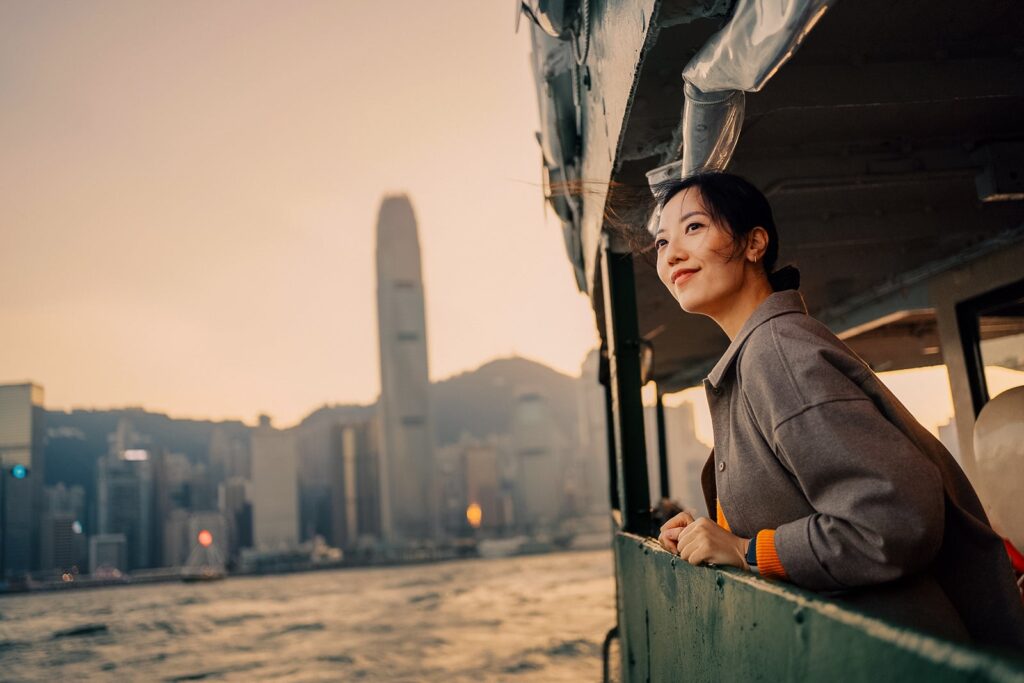 Your entire journey well being tick list young traveler enjoying skyline view of hong kong and victoria harbour while on star ferry d3sign.jp .jpeg