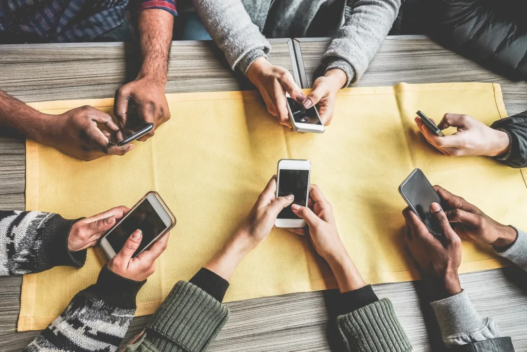 group of friends smartphones table on phone.webp.webp