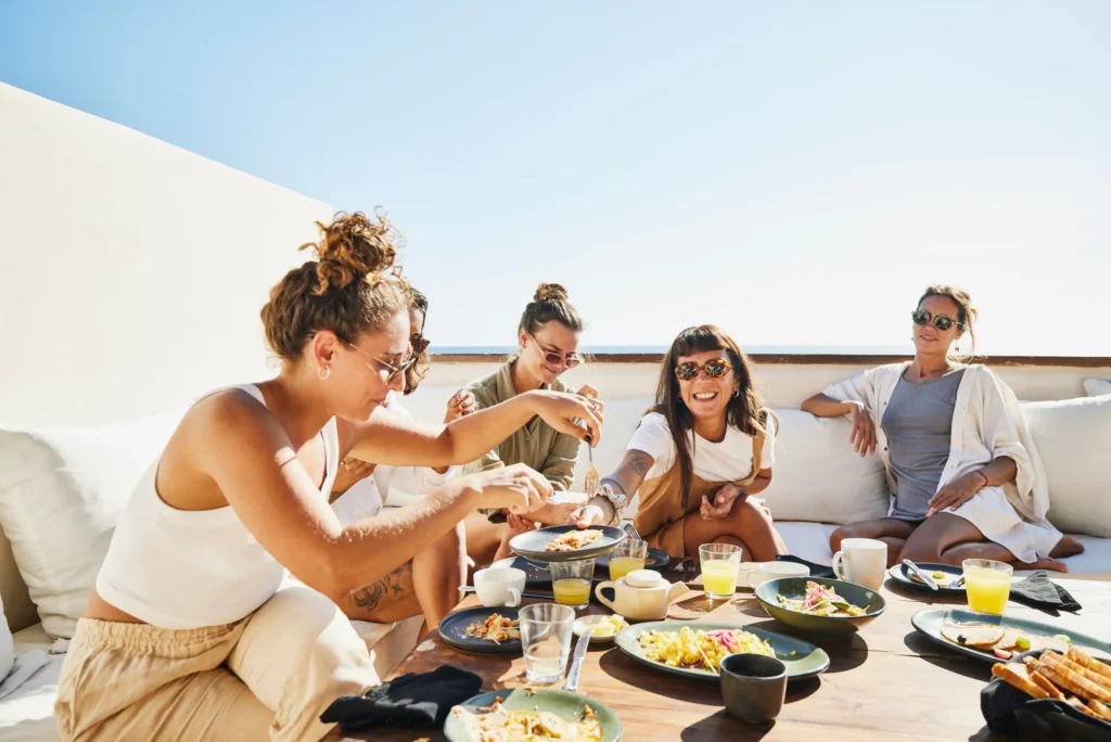 group women sitting table eating.webp.webp