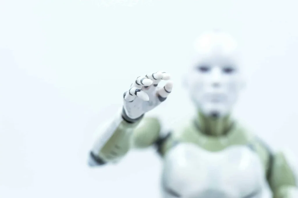 white robot reaching hand out scaled.webp.webp